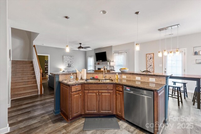 3216 Bridgewick Rd, Waxhaw, NC 28173 - kitchen with a kitchen island with sink, a sink, a ceiling fan, wood finished floors, and dishwasher