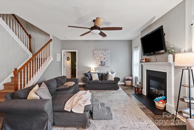 3216 Bridgewick Rd, Waxhaw, NC 28173 - living room featuring ceiling fan, a glass covered fireplace, dark wood-type flooring, and stairway