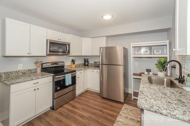 kitchen with sink, white cabinets, and stainless steel appliances