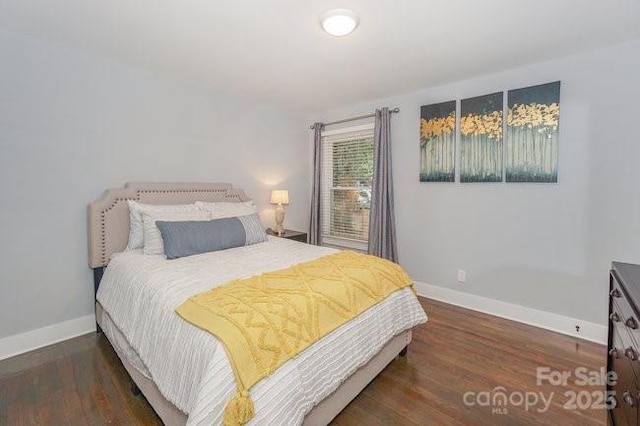 bedroom with dark wood-type flooring