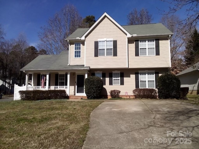 view of front of home featuring covered porch and a front lawn