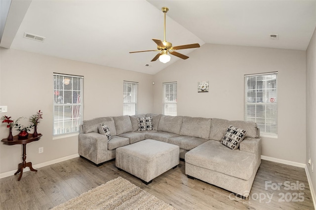 living room with ceiling fan, lofted ceiling, and hardwood / wood-style floors