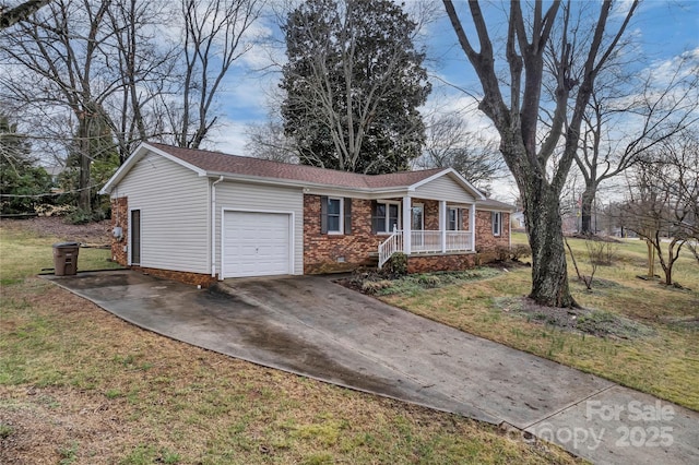 single story home with covered porch, concrete driveway, an attached garage, a front yard, and crawl space