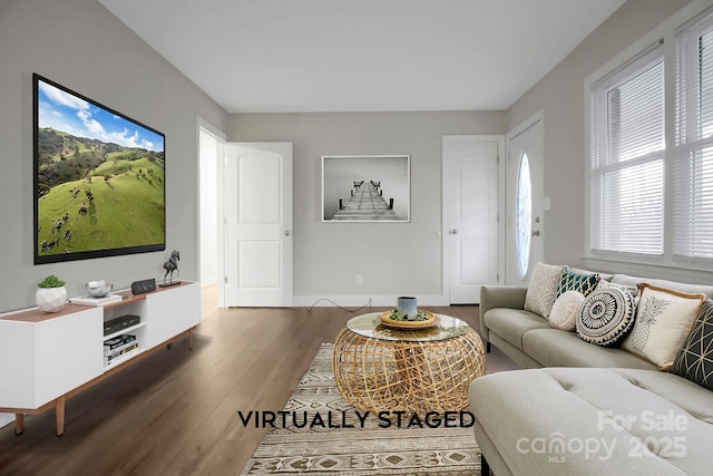 living area featuring wood finished floors and baseboards