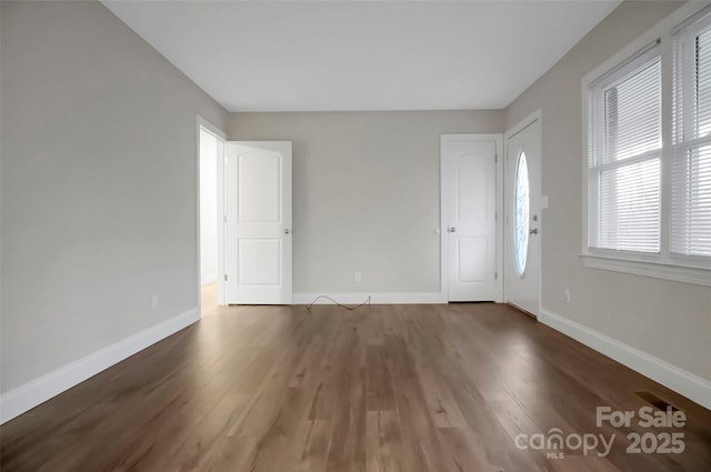 interior space featuring wood finished floors and baseboards