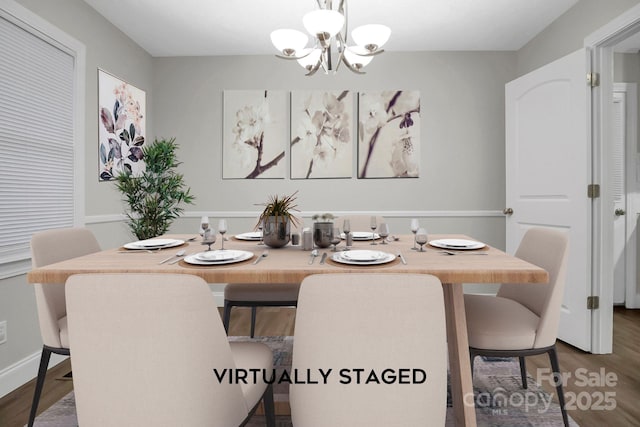 dining space featuring an inviting chandelier and wood finished floors