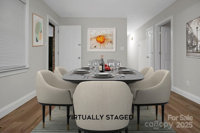 dining area featuring baseboards and wood finished floors