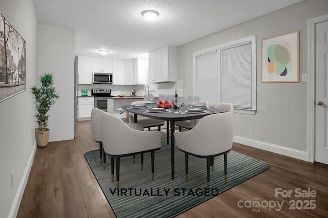 dining space with dark wood finished floors and baseboards