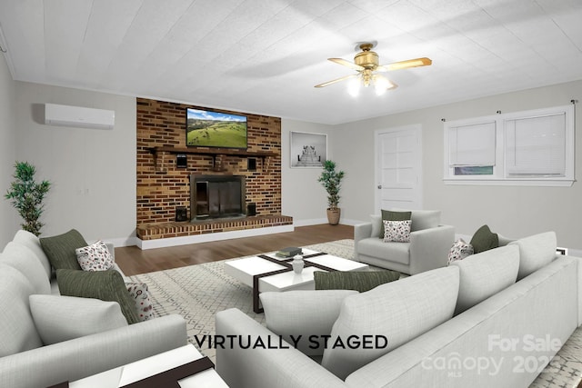 living area featuring ceiling fan, a wall unit AC, a fireplace, wood finished floors, and baseboards