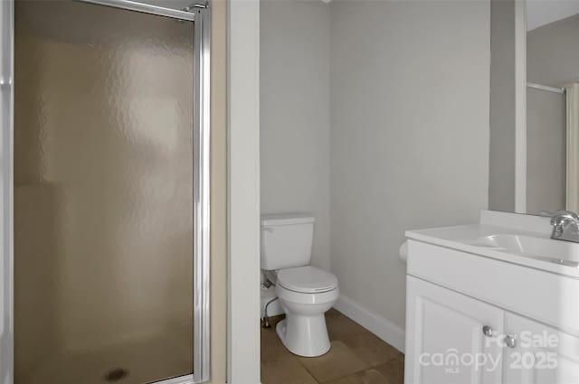 full bathroom featuring baseboards, toilet, tile patterned floors, vanity, and a shower stall