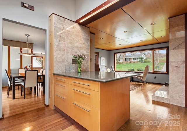 kitchen with modern cabinets, decorative backsplash, recessed lighting, and light wood-style floors