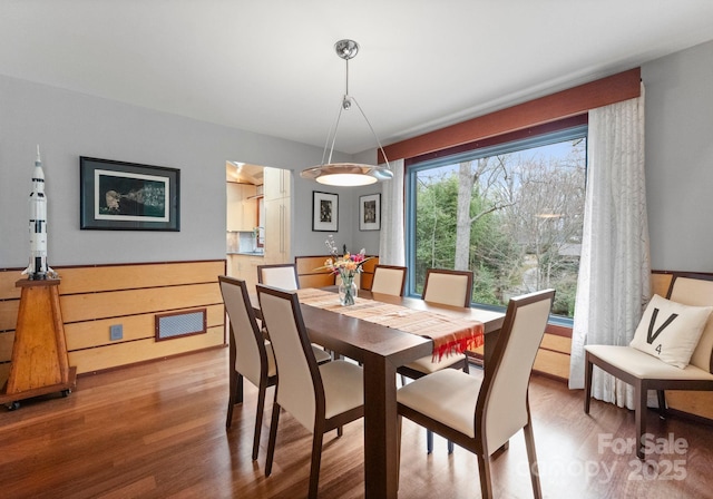 dining room with wood finished floors and visible vents