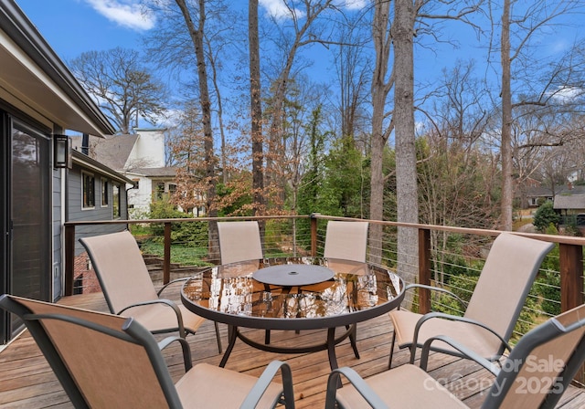 wooden terrace featuring outdoor dining area