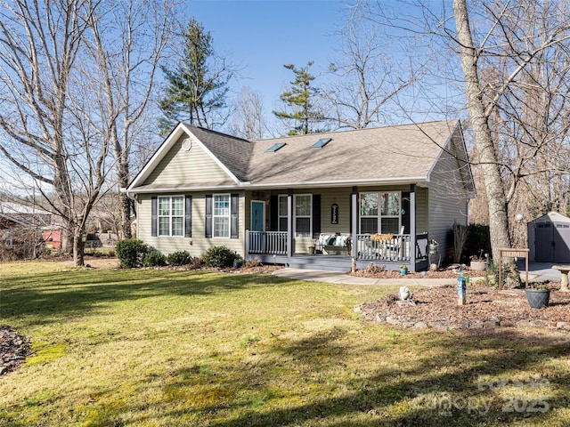 single story home featuring a storage unit, covered porch, and a front lawn