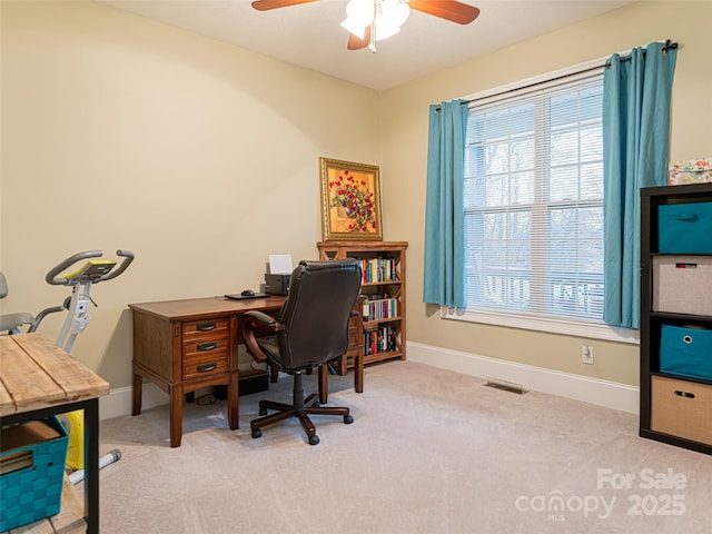 office with light carpet and ceiling fan