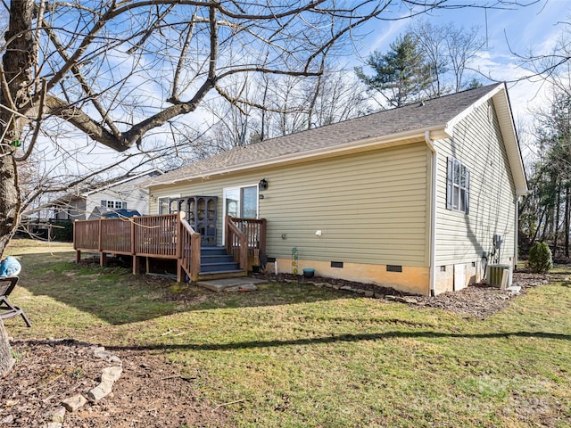 back of property featuring a wooden deck and a yard