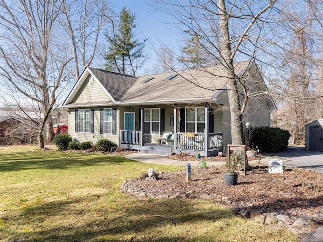 ranch-style house with a porch, a shed, and a front yard