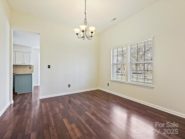 unfurnished dining area with dark wood-style flooring, visible vents, and baseboards