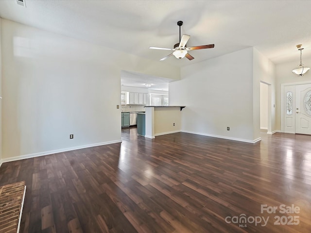 unfurnished living room with a ceiling fan, dark wood-style flooring, and baseboards