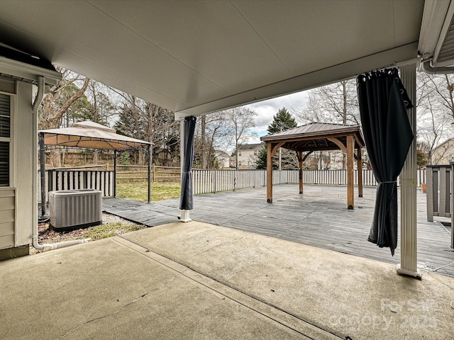 view of patio / terrace with a wooden deck, fence, cooling unit, and a gazebo