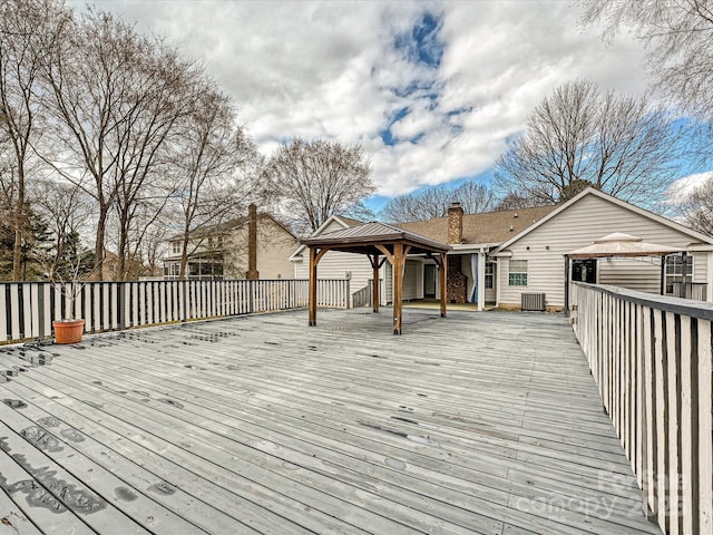 wooden deck with a gazebo and central AC unit