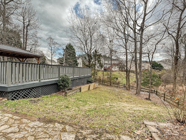 view of yard with fence and a wooden deck