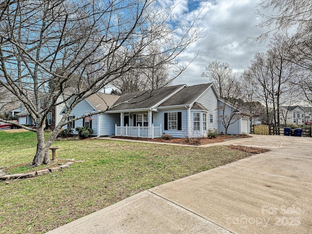 ranch-style home with a garage, covered porch, a front lawn, and concrete driveway