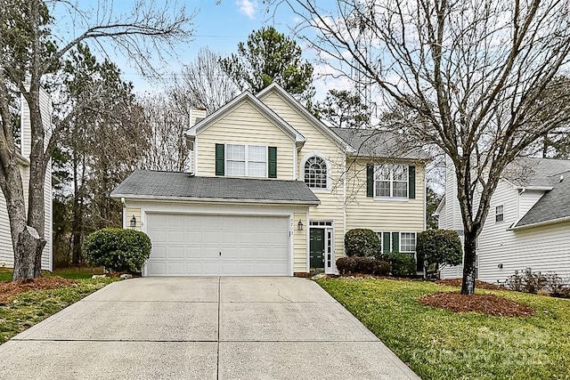 view of front property with a garage and a front lawn