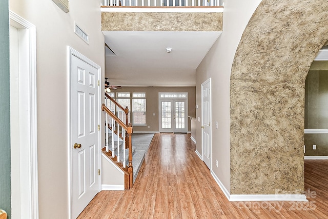 foyer featuring light hardwood / wood-style flooring and french doors