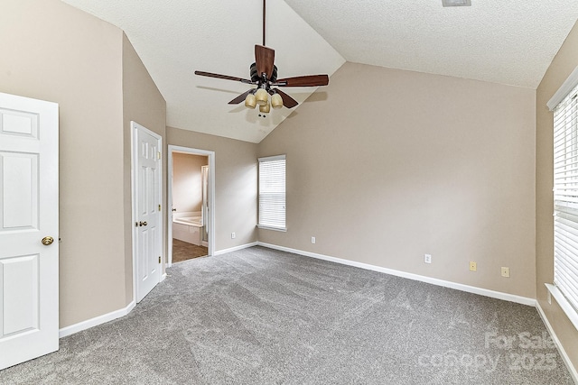 unfurnished bedroom with ceiling fan, carpet, connected bathroom, a textured ceiling, and vaulted ceiling