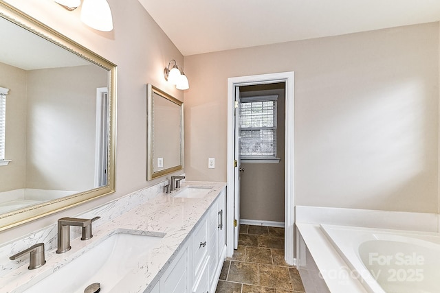 bathroom featuring vanity and a bath