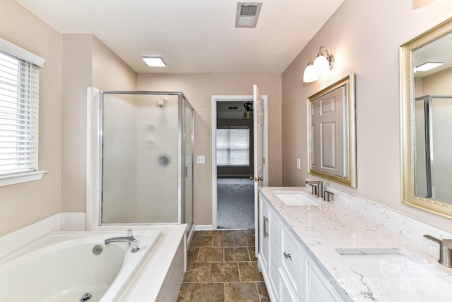 bathroom with vanity, a wealth of natural light, and plus walk in shower