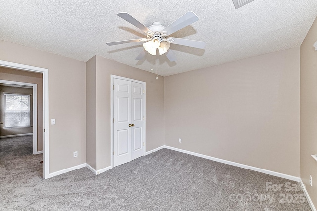 unfurnished bedroom with ceiling fan, a textured ceiling, and carpet flooring