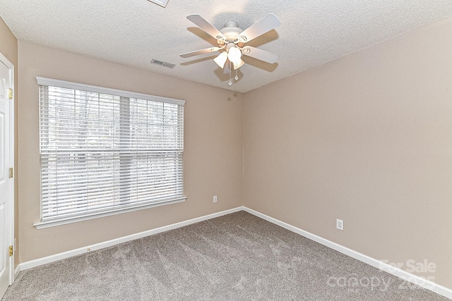 unfurnished room with carpet flooring, a textured ceiling, and ceiling fan