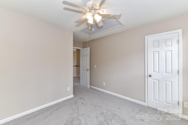 unfurnished bedroom featuring ceiling fan, light colored carpet, and a textured ceiling