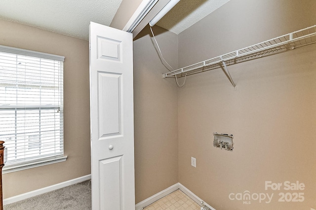 laundry area with hookup for a washing machine and a textured ceiling