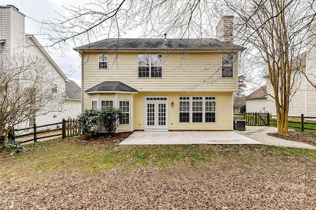 back of house featuring cooling unit, a yard, a patio area, and french doors