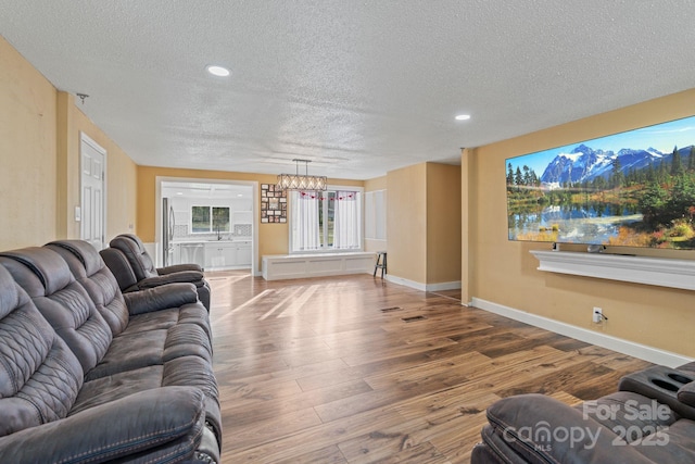 living room with a textured ceiling and hardwood / wood-style flooring