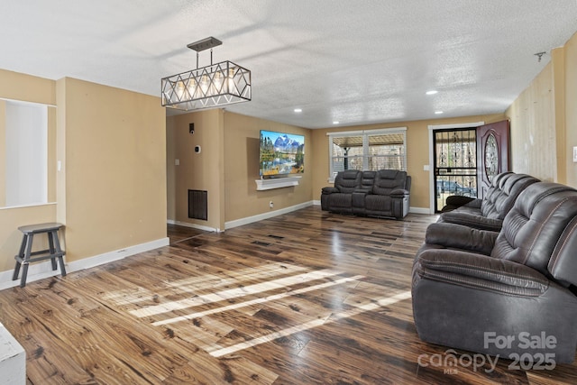 living room with dark hardwood / wood-style flooring and a textured ceiling