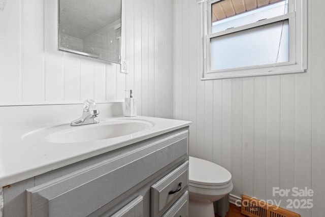 bathroom featuring vanity and toilet