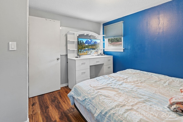 bedroom featuring dark hardwood / wood-style floors and a textured ceiling