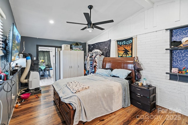 bedroom featuring brick wall, ceiling fan, dark wood-type flooring, and lofted ceiling with beams