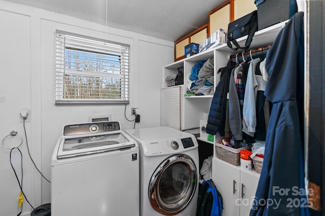 clothes washing area featuring independent washer and dryer