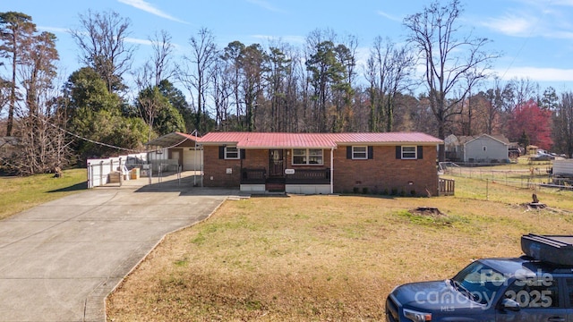 ranch-style home with covered porch and a front yard