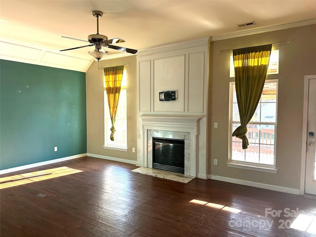 unfurnished living room featuring ceiling fan, a premium fireplace, and dark hardwood / wood-style flooring