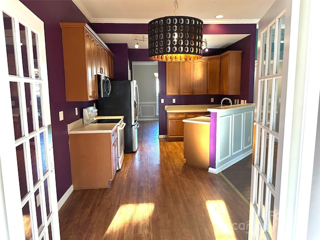 kitchen featuring white range with electric stovetop, sink, hanging light fixtures, crown molding, and dark wood-type flooring