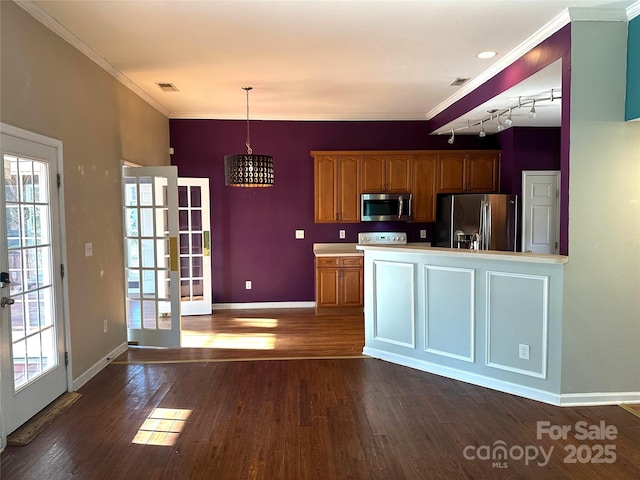 kitchen featuring french doors, crown molding, decorative light fixtures, appliances with stainless steel finishes, and dark hardwood / wood-style floors