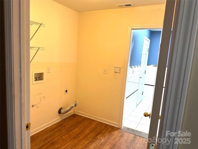 washroom with electric dryer hookup, hookup for a washing machine, and dark wood-type flooring