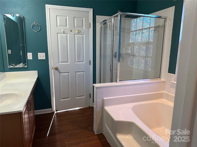 bathroom featuring vanity, separate shower and tub, and hardwood / wood-style floors