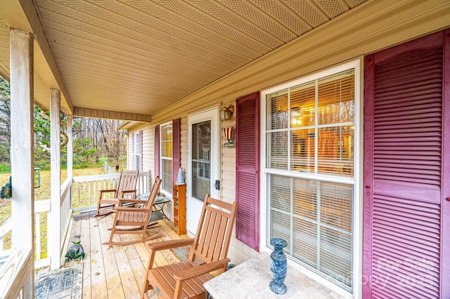 wooden terrace featuring covered porch